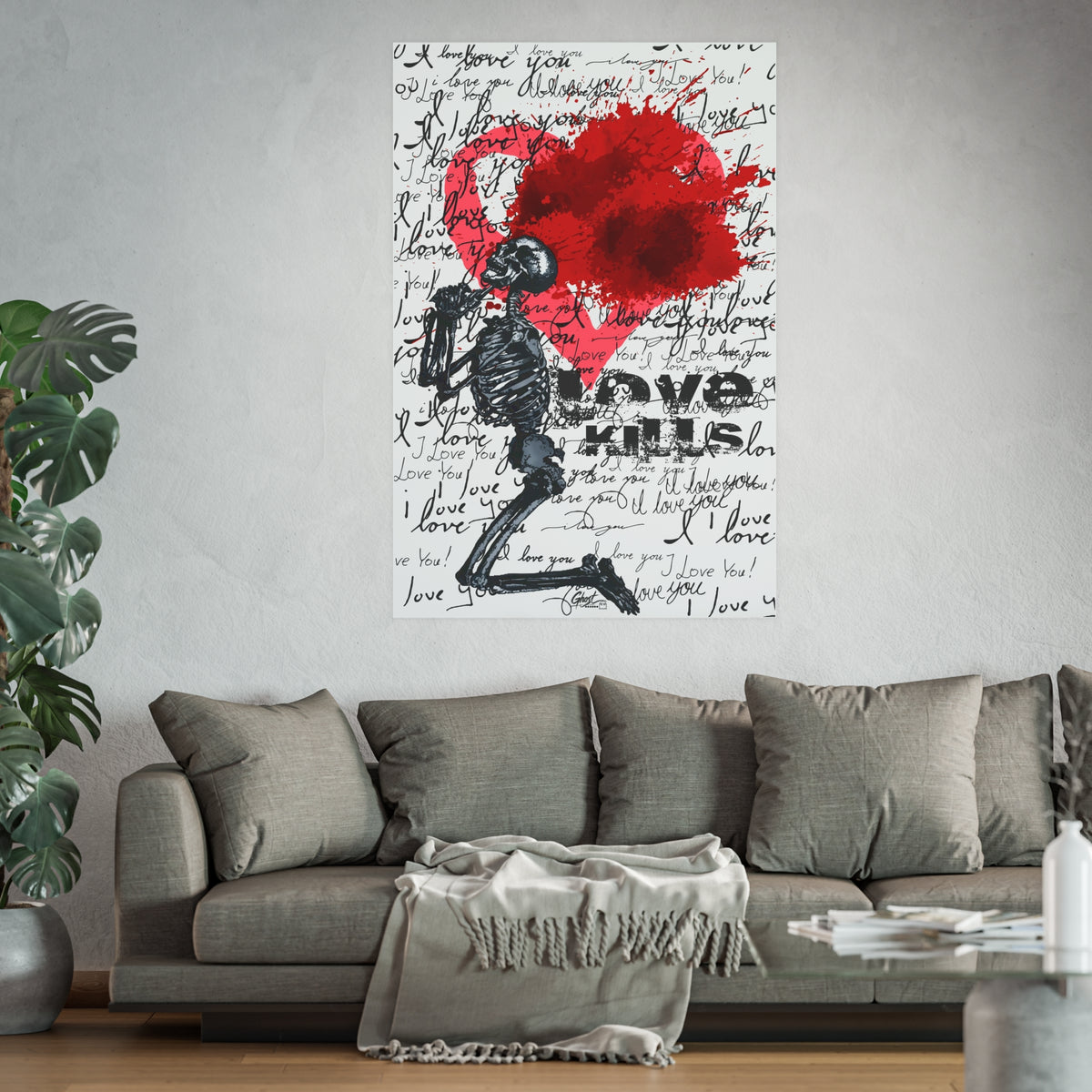 Love Kills Mindset Series art poster above a gray sofa, kneeling skeleton before a burst red heart