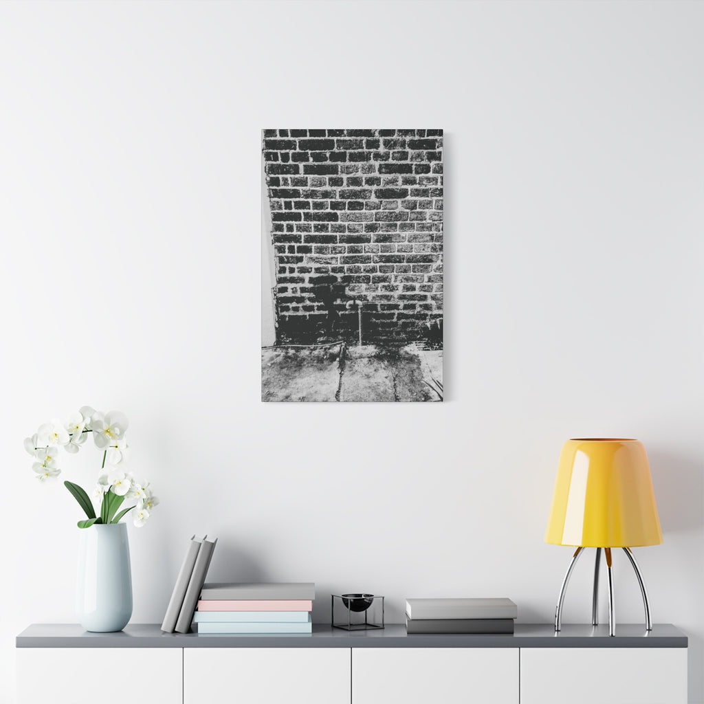 A Little Hiking in Charleston canvas on a white wall above a console, high-contrast brick wall with a tiny stencil hiker