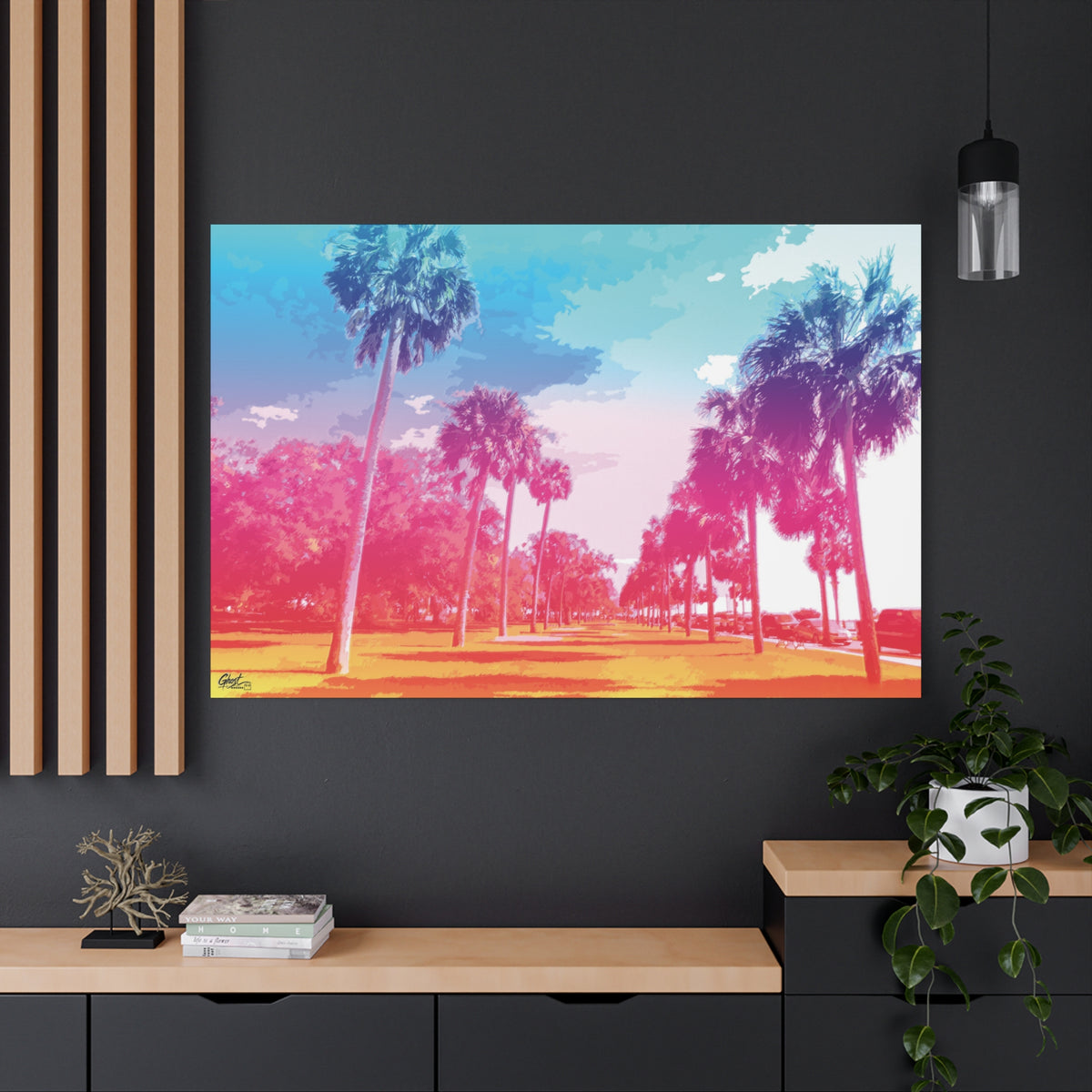 The Battery Tropical Edition oversized canvas on a charcoal wall by wood slats, palms in a pink and turquoise sunset