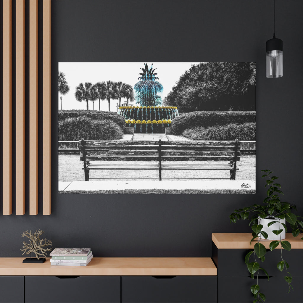 The Pineapple of Peace canvas on a charcoal wall by wood slats, stylized pineapple fountain with palmettos and a park bench