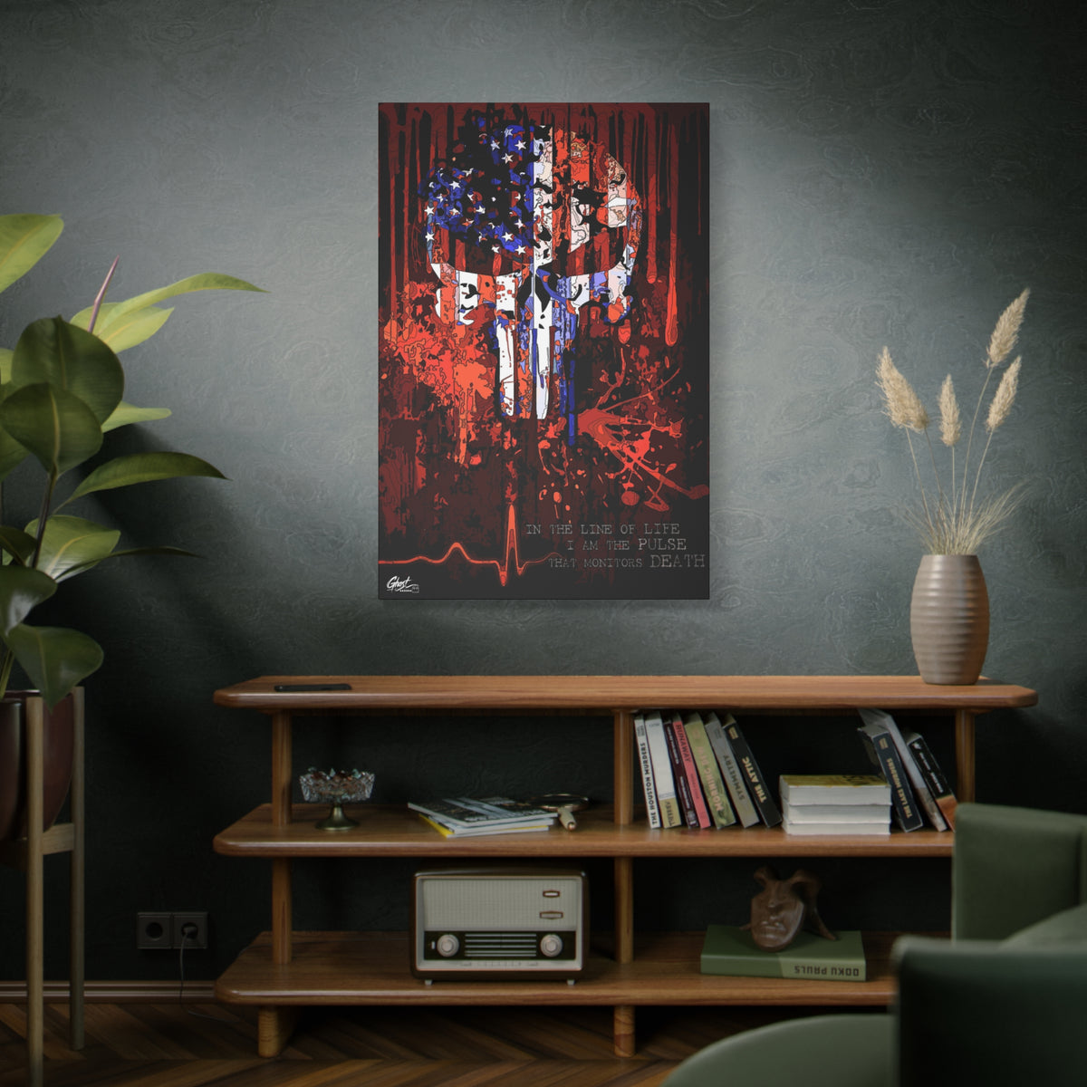 The Vigilante large canvas on a green-gray wall over bookshelves, red, white and blue flag skull on black