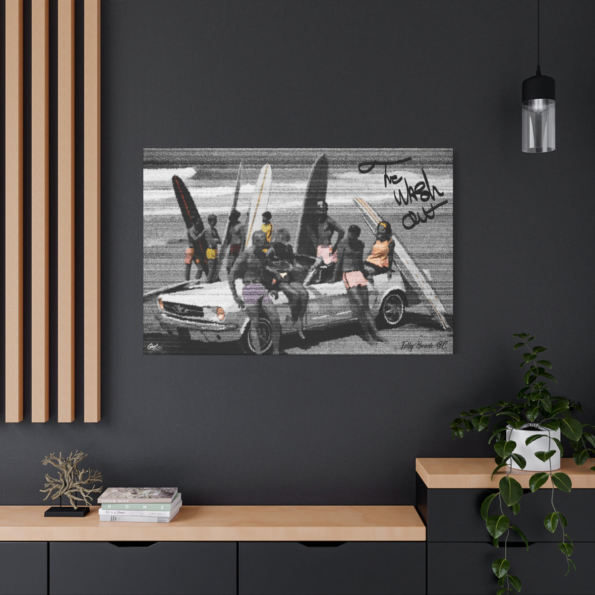 The Wash Out large canvas on a charcoal wall over an oak shelf, grainy beach-day photo with a surfboard-loaded convertible
