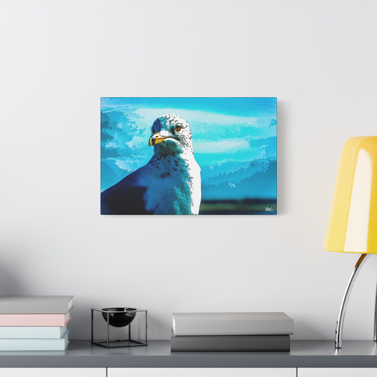 Carolina Seagull oversized canvas beside a yellow desk lamp, close-up seagull with a sharp eye and yellow beak on bright blue
