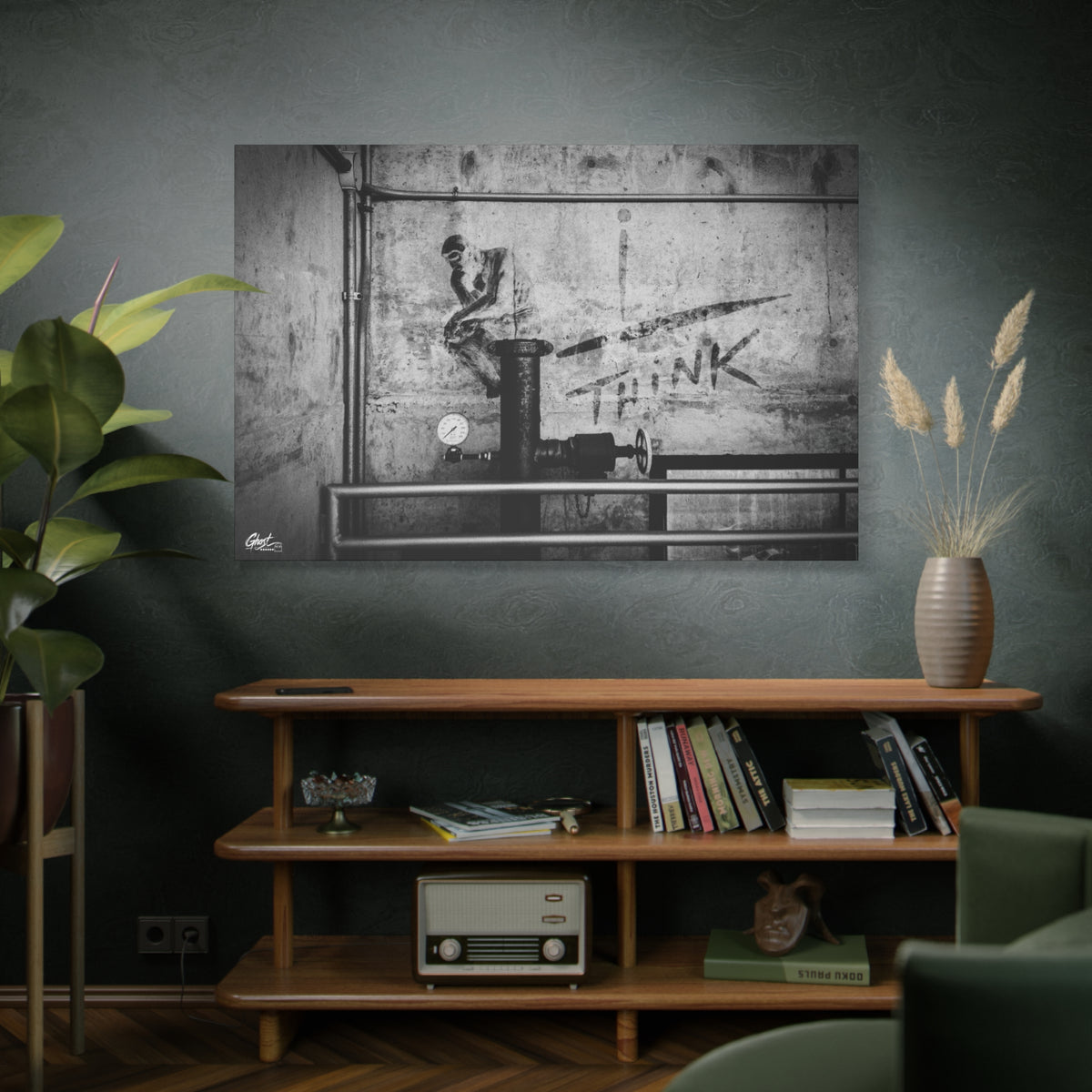 I Overthink oversized canvas above a wooden bookshelf, stenciled THINK with pipes and gauges on concrete, black and white