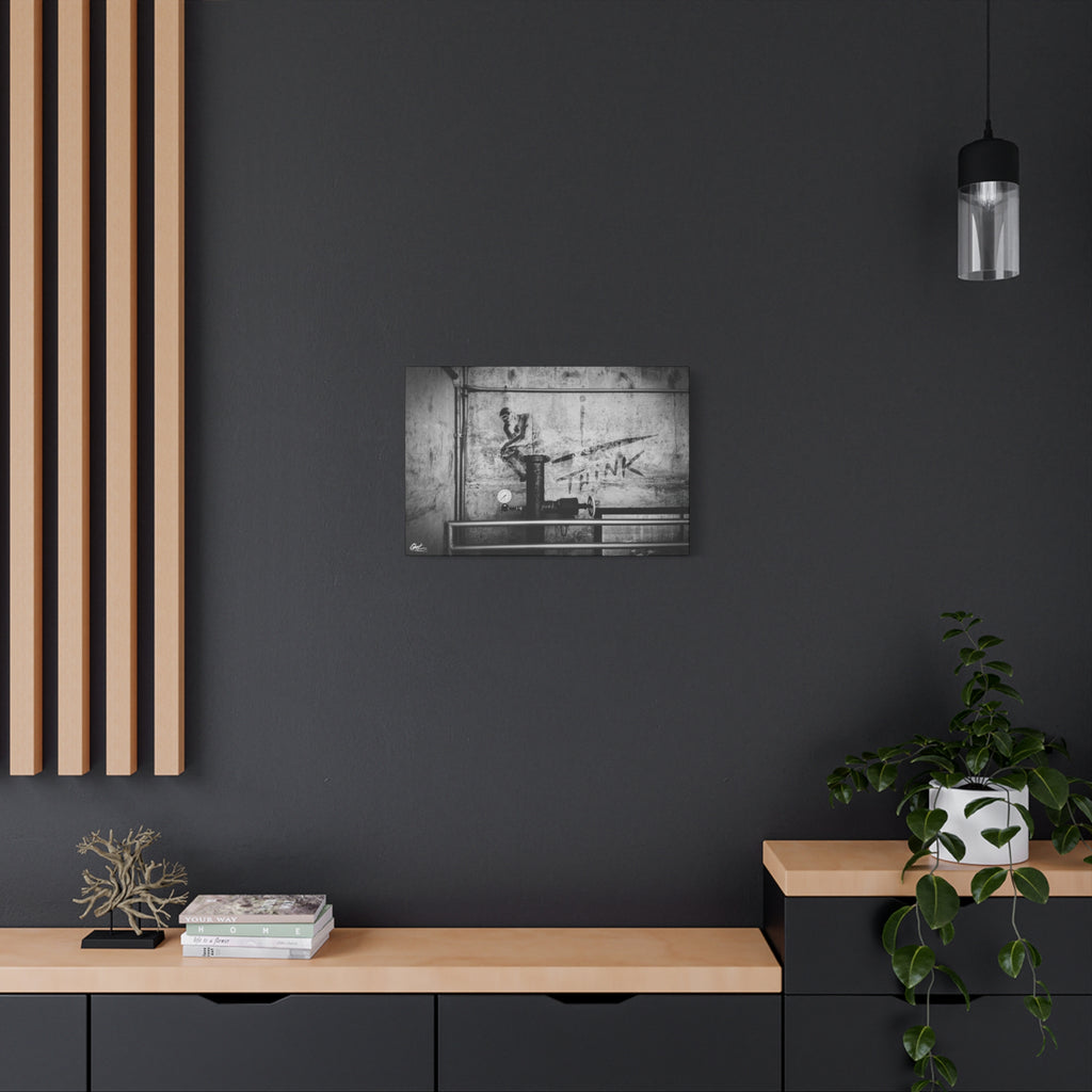 I Overthink medium canvas on a charcoal wall by wood slats, gritty parking-garage wall with a stenciled THINK