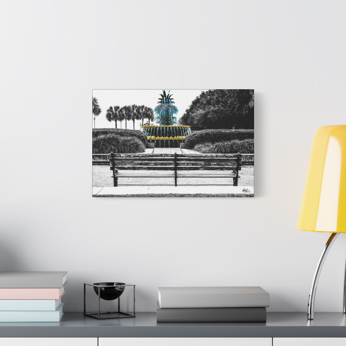 The Pineapple of Peace canvas beside a yellow desk lamp, stylized pineapple fountain with palmettos and a park bench