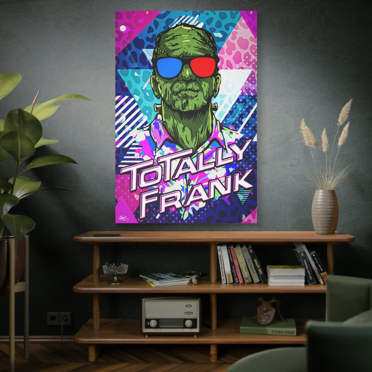 Monster Vibes oversized canvas above a wooden bookshelf, green monster in red-and-blue 3D glasses and a tropical shirt