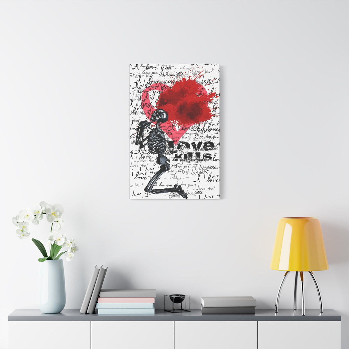 Love Kills medium canvas on a white wall above a console, black linework skeleton with red splatter heart