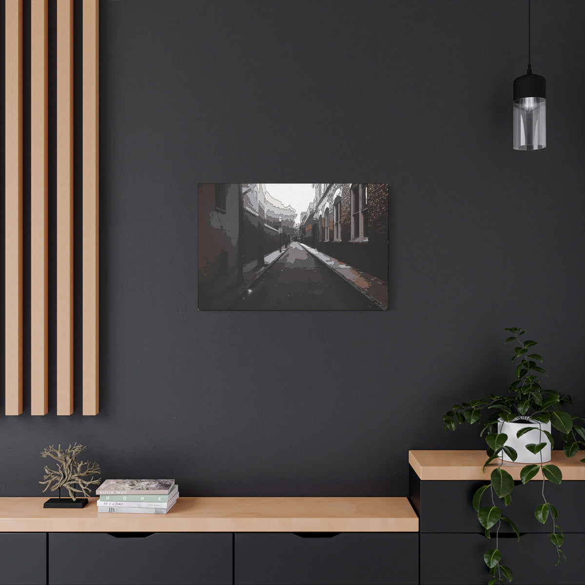 Charleston One Way small canvas on a charcoal wall over an oak shelf, moody alley with old brick walls and long shadows