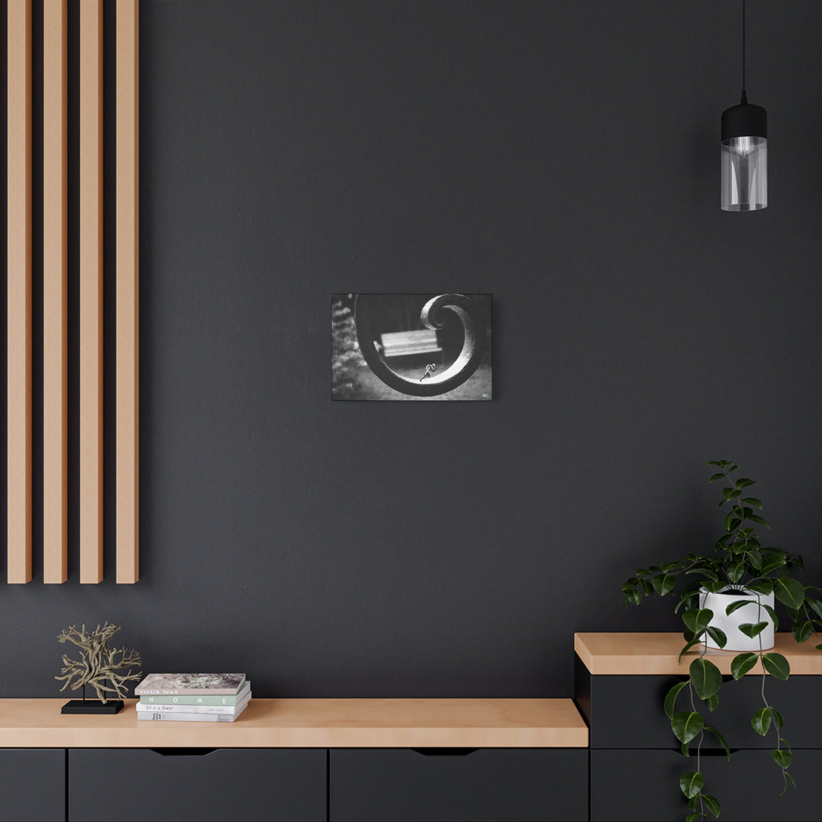 A Man in Charleston small canvas on a charcoal wall by wood slats, tiny running figure inside a curled wrought-iron scroll in grainy black and white