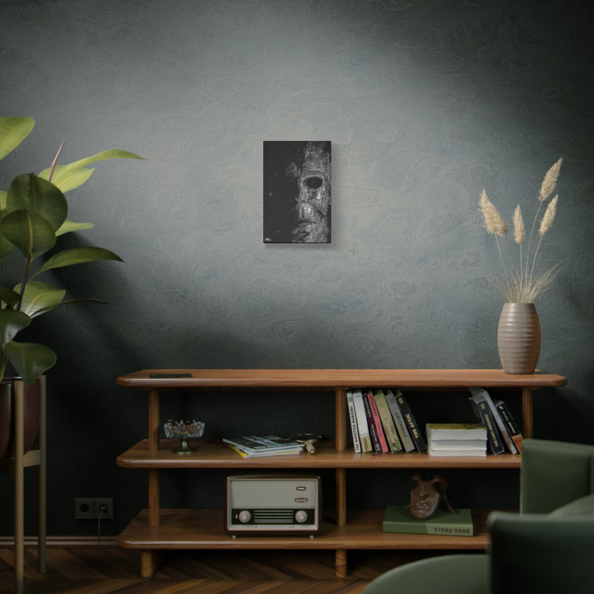 Stalk at Night small canvas on a green-gray wall over bookshelves, scratchy pen-and-ink mask emerging from darkness