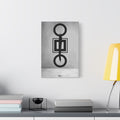 Down is Up small canvas beside a yellow desk lamp, circles and squares crossed by a bold black brushstroke