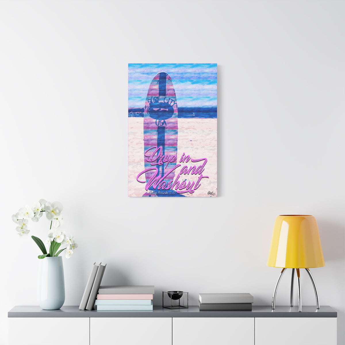 Drop In and Wash Out, Folly Beach canvas on a white wall above a console, sun-bleached surfboard art in soft pinks and blues