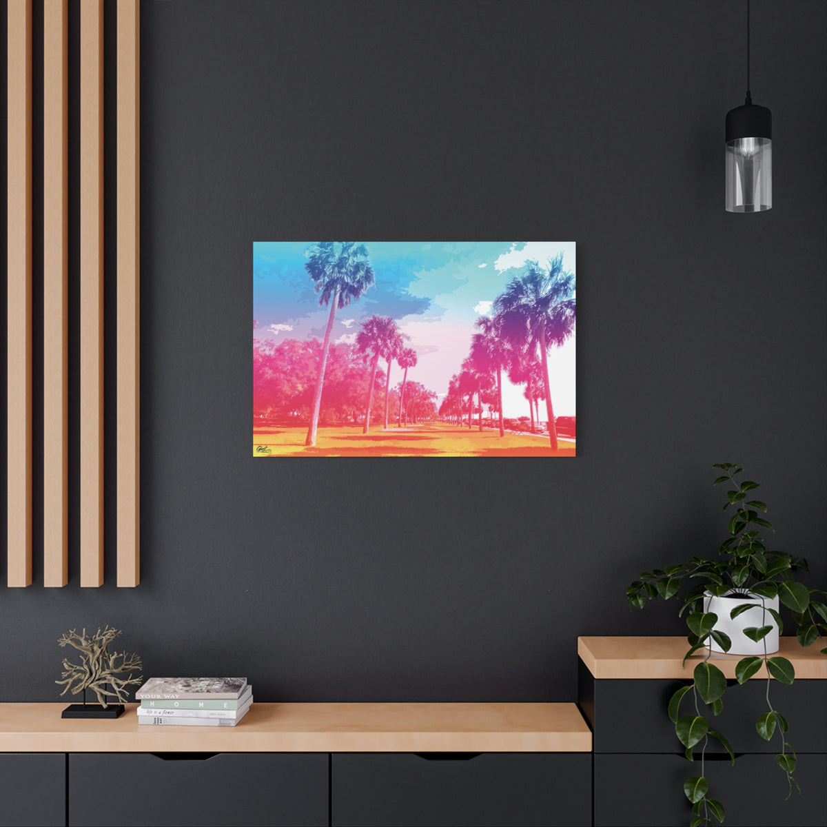 The Battery Tropical Edition large canvas on a charcoal wall by wood slats, palms in a pink and turquoise sunset