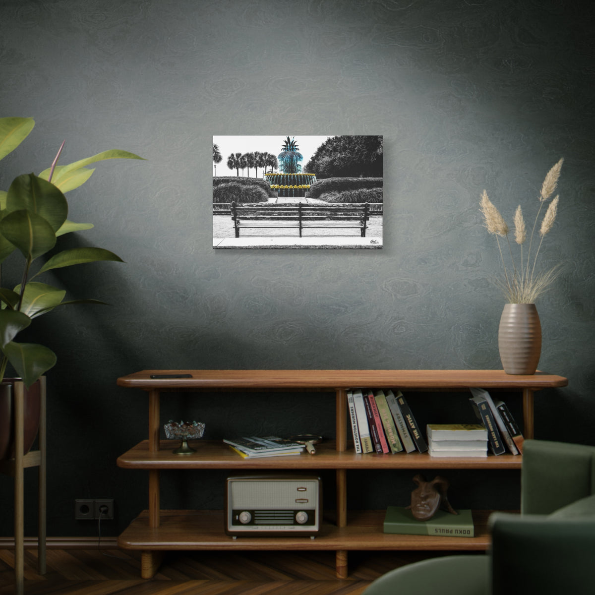 The Pineapple of Peace medium canvas on a green-gray wall over bookshelves, pineapple fountain behind a park bench