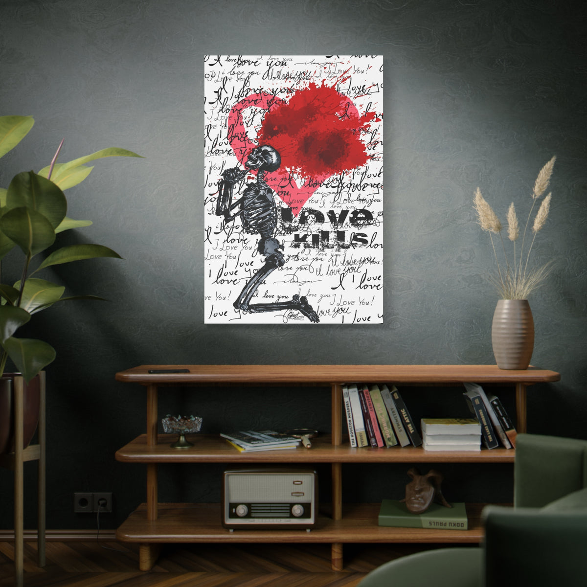 Love Kills large canvas above a wooden bookshelf, kneeling skeleton before a burst pink and crimson heart
