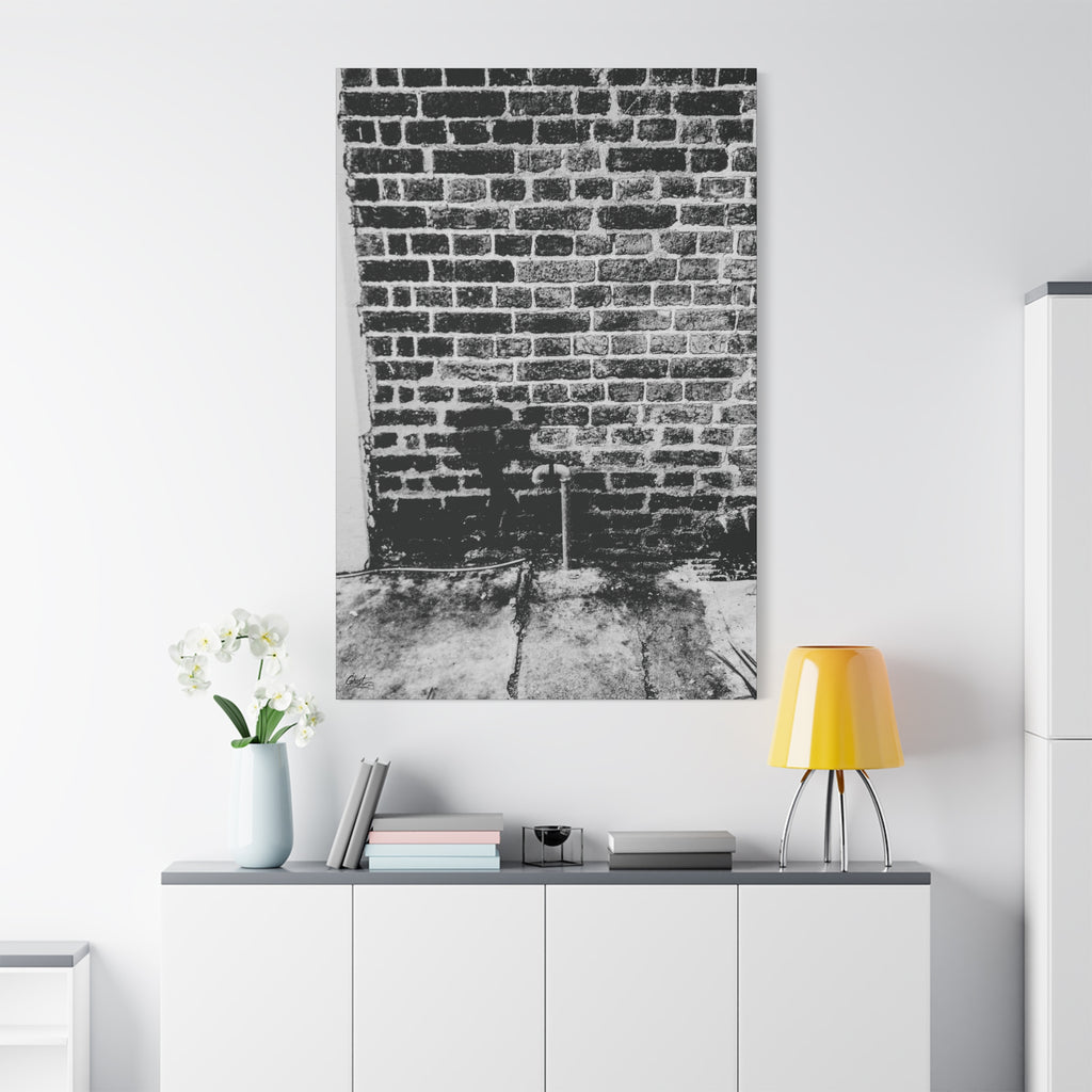 A Little Hiking in Charleston canvas on a white wall over a sideboard, high-contrast brick wall with a tiny stencil hiker