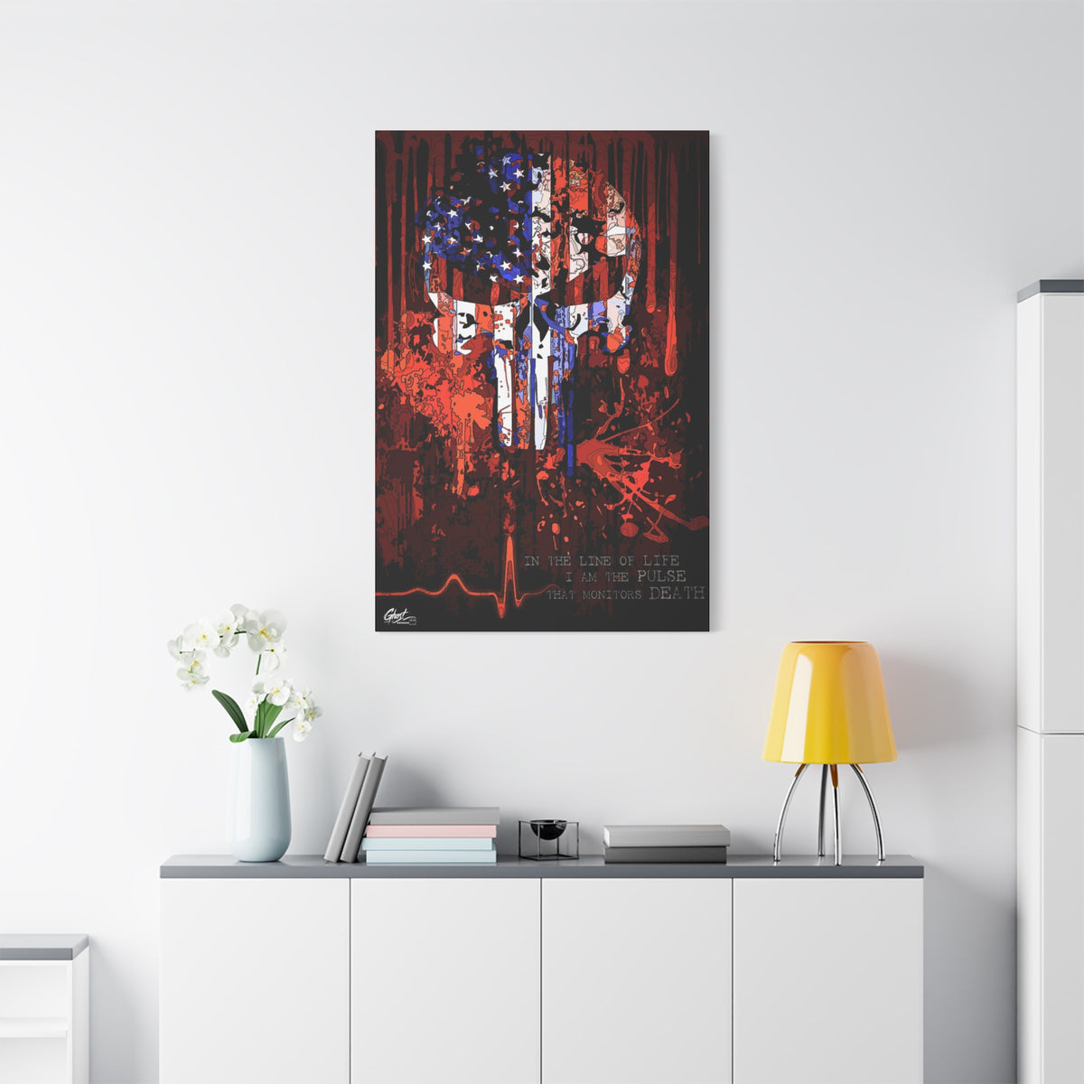 The Vigilante large canvas on a white wall over a sideboard, red, white and blue flag skull on black