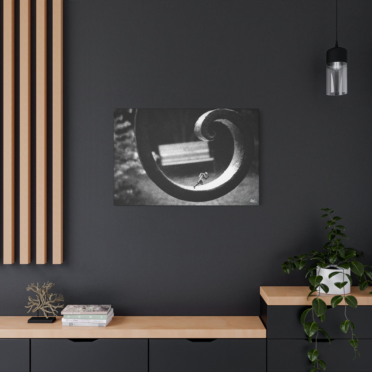 A Man in Charleston large canvas on a charcoal wall over an oak shelf, tiny running figure inside a curled wrought-iron scroll in grainy black and white