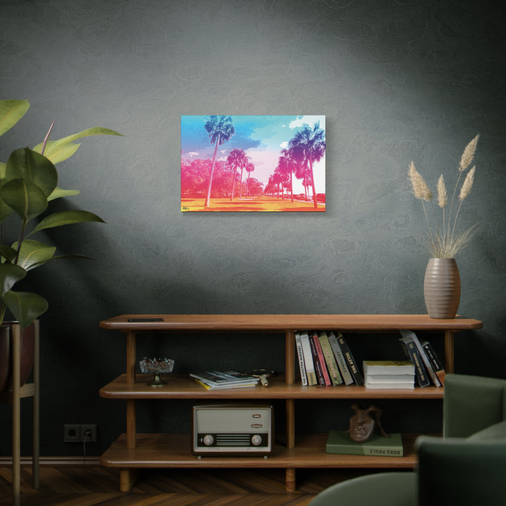 The Battery Tropical Edition medium canvas on a green-gray wall over bookshelves, palms in a pink and turquoise sunset