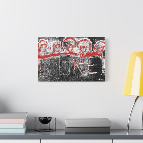 Lowcountry Medicine oversized canvas beside a yellow desk lamp, red-outlined faces over engraved lettering in a grungy sidewalk