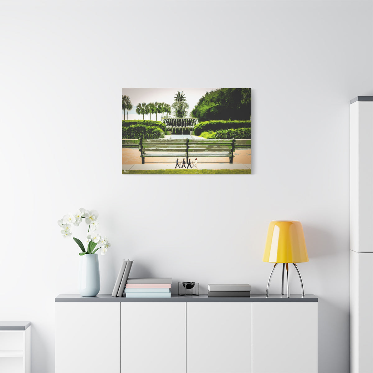 Pineapple Crossing canvas above a white sideboard and yellow lamp, painterly park scene with the pineapple fountain
