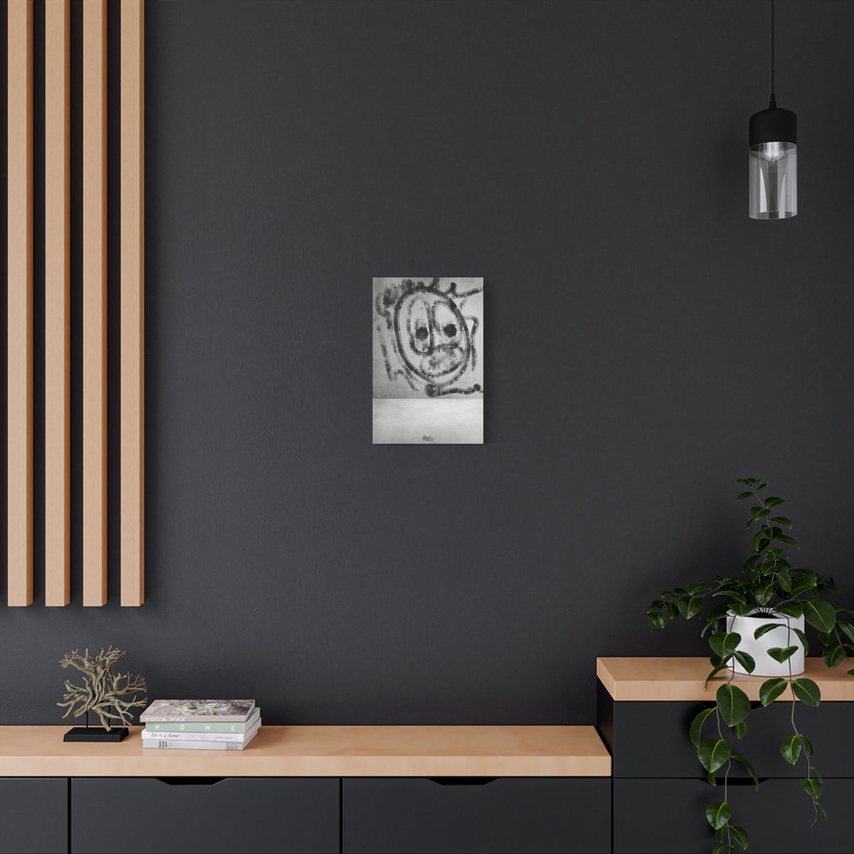 Thinking Out Loud small canvas on a charcoal wall over an oak shelf, black-and-white abstract face with blurred edges