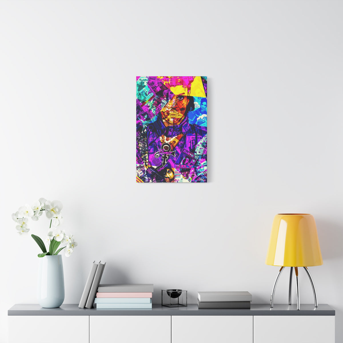 The Symbol small canvas over a console with white flowers, portrait in a yellow hat over a purple and teal magazine collage
