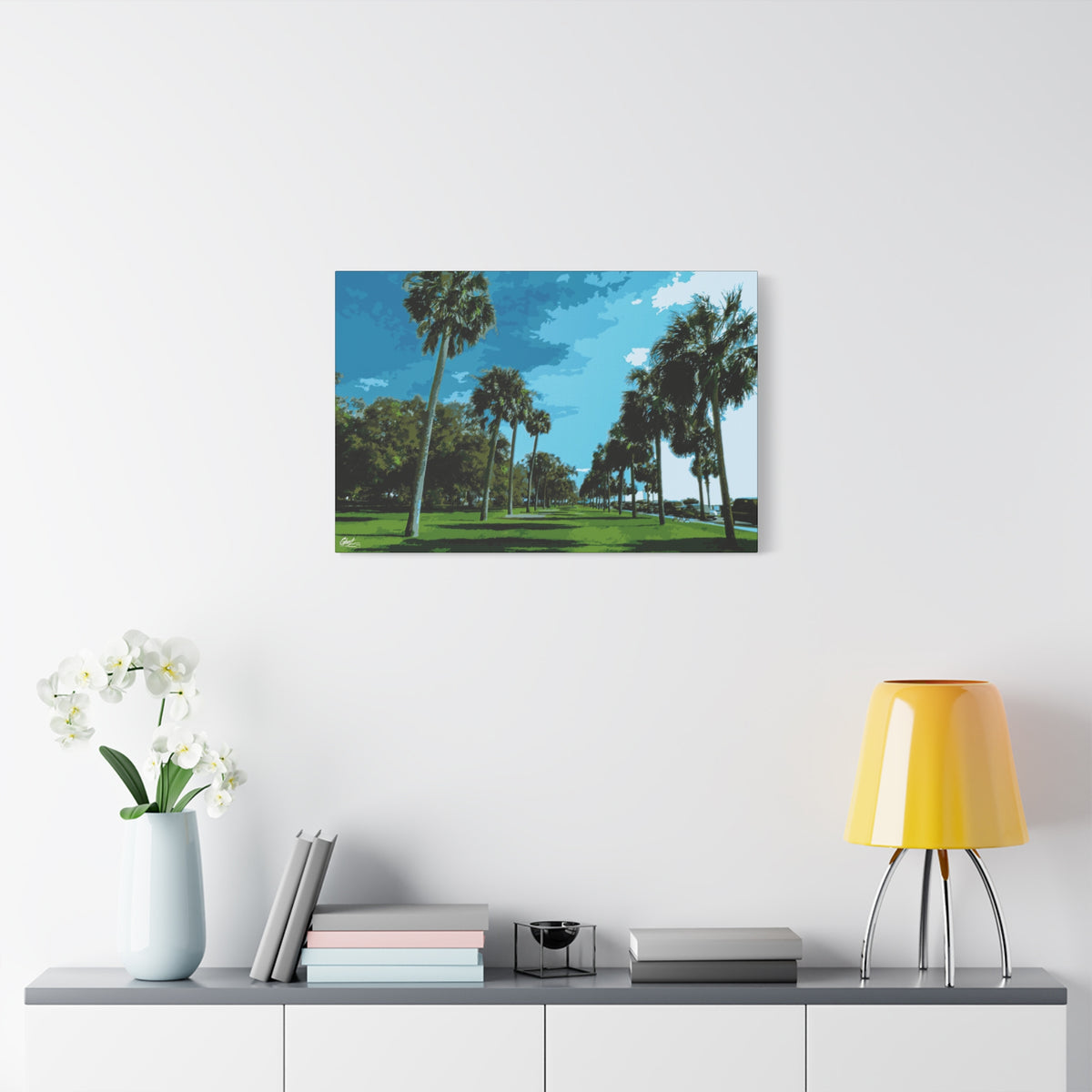 The Battery (Original) oversized canvas on a white wall above a console, sunlit palms and long shadows by the water