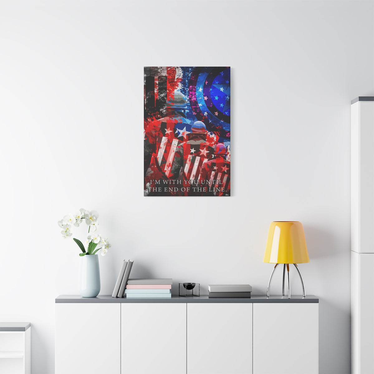 9/11 Never Forget small canvas above a white sideboard and yellow lamp, patriotic tribute in red, white, blue and smoke gray