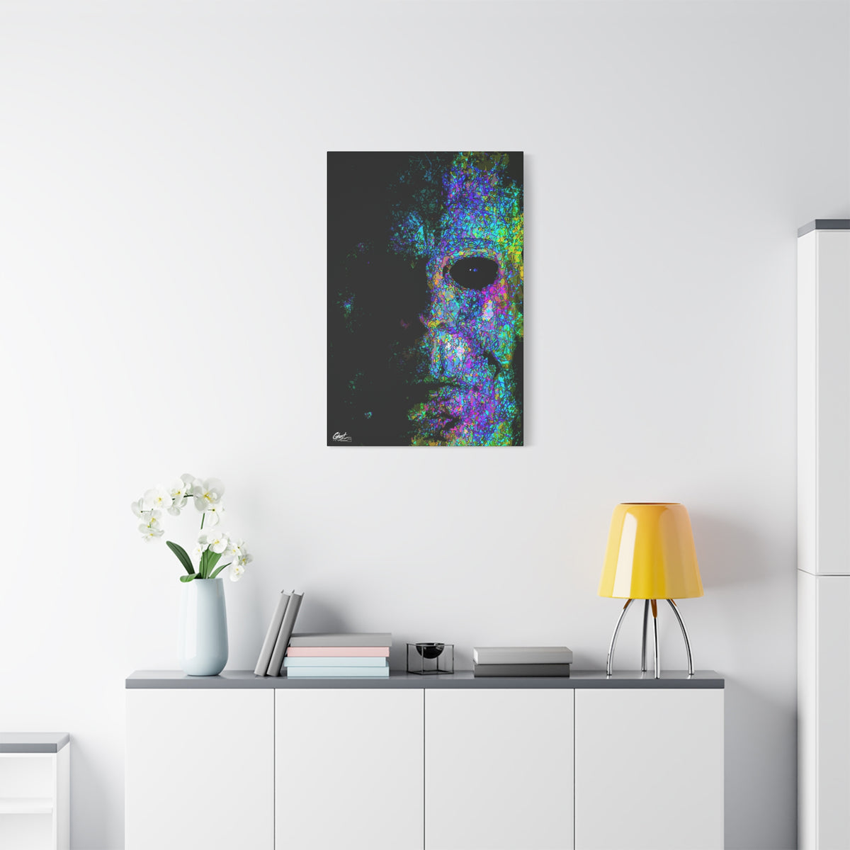 Stalk at Night, Neon Edition small canvas above a white sideboard and yellow lamp, half-shadowed mask in colorful sketch lines