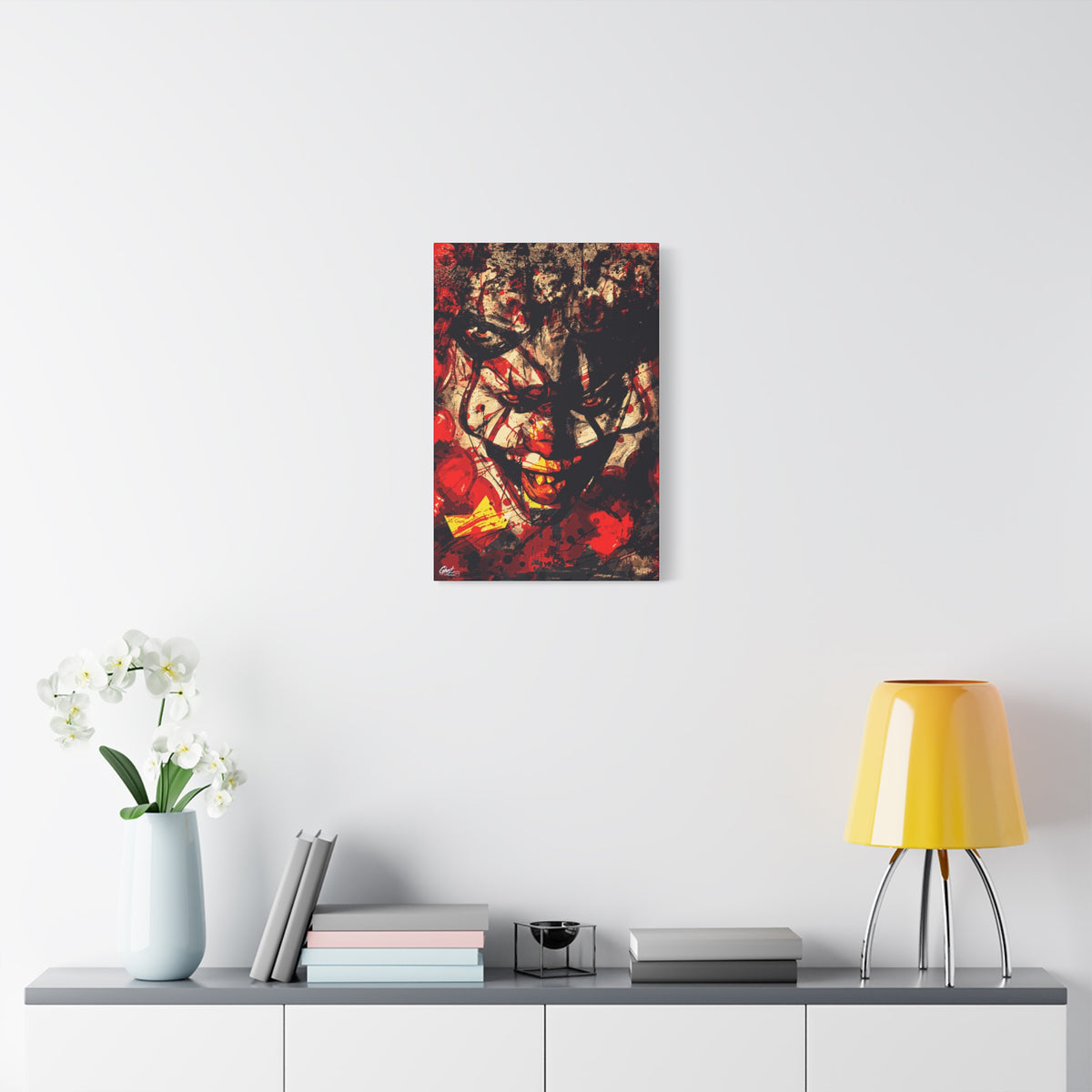 Down in a Drain small canvas over a console with white flowers, leering clown face in distressed red, black and cream