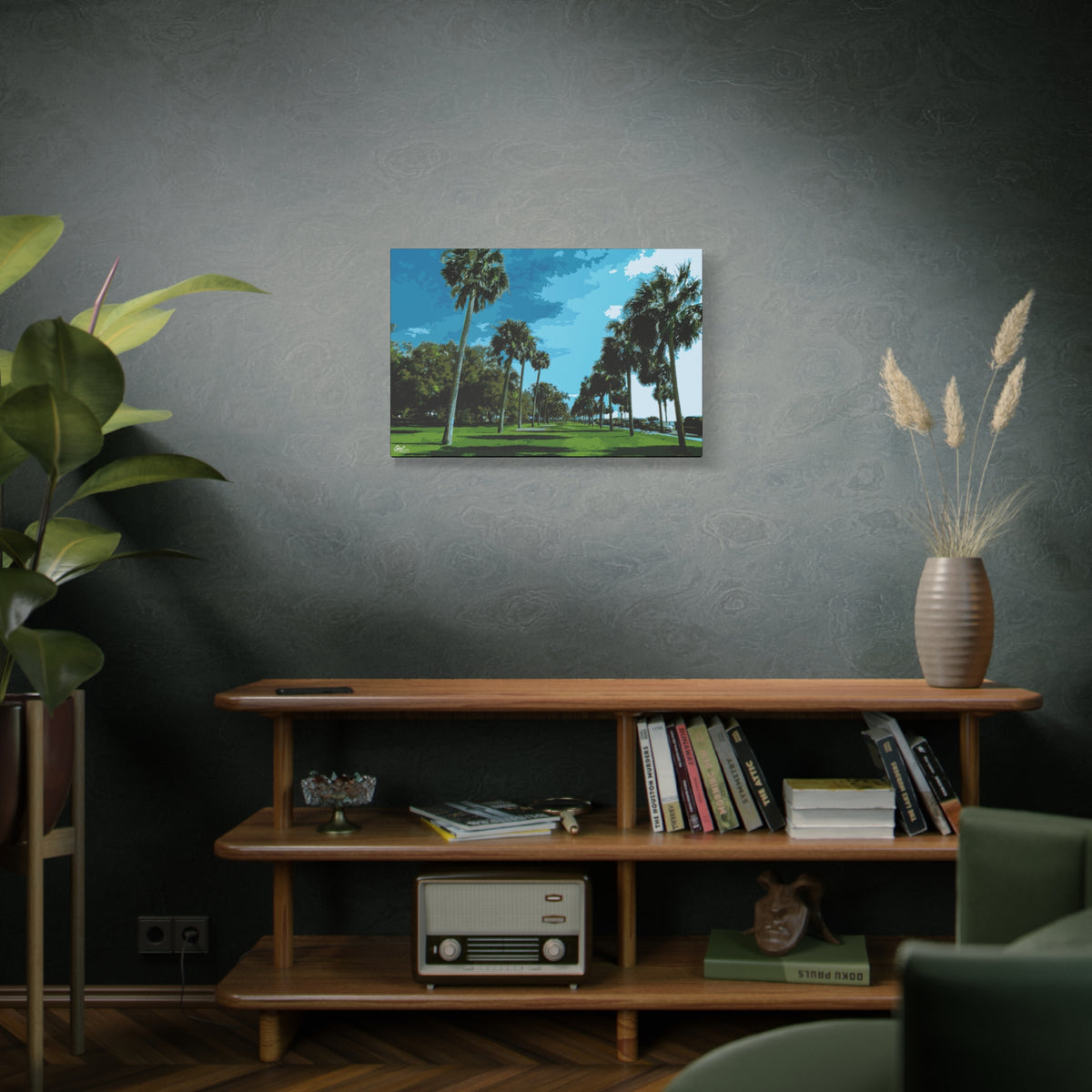 The Battery (Original) medium canvas above a wooden bookshelf, sunlit palms and long shadows by the water