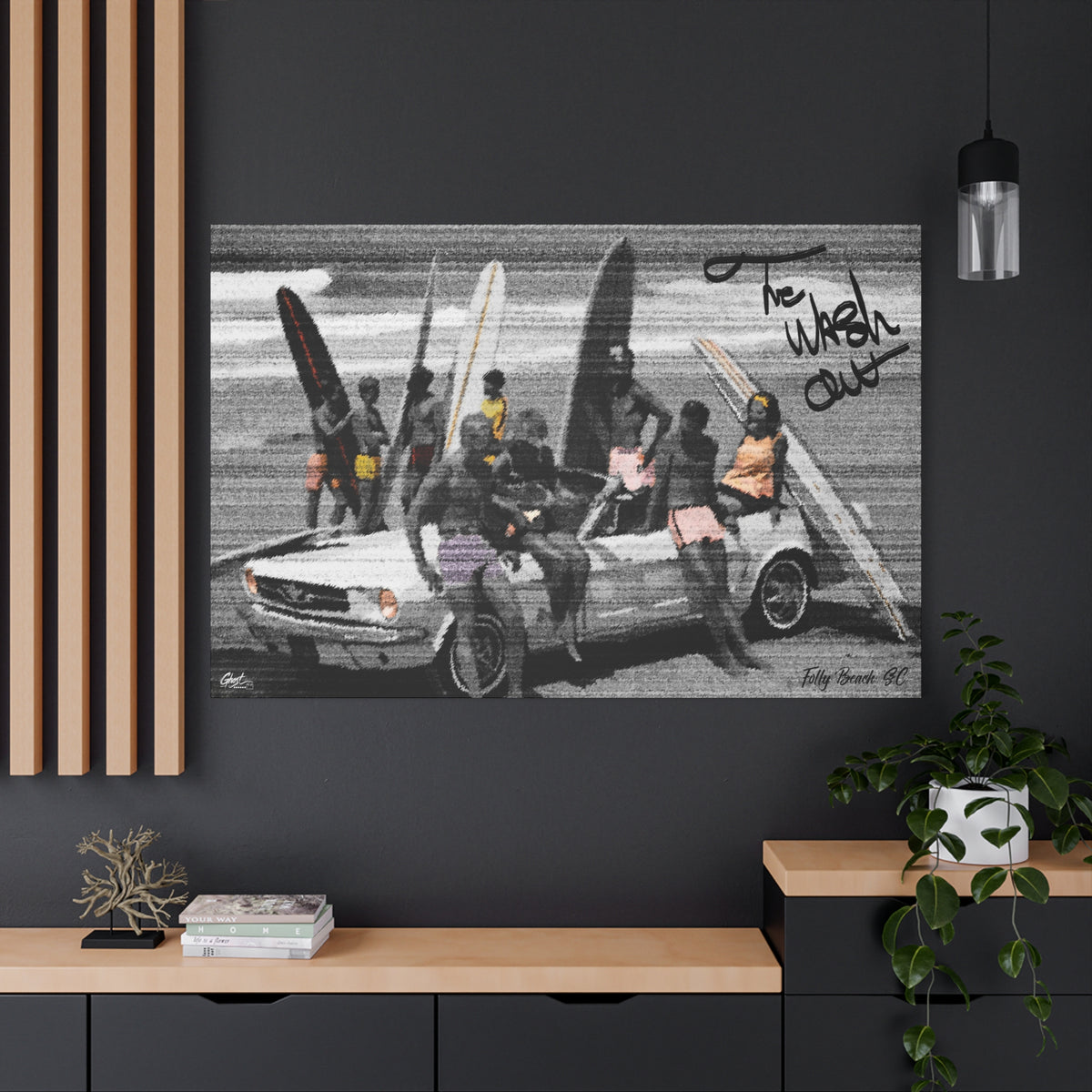 The Wash Out canvas on a charcoal wall by wood slats, friends with surfboards piled on a vintage convertible, black and white