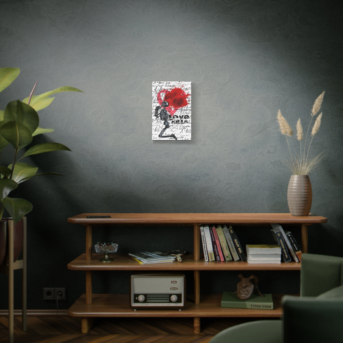 Love Kills small canvas on a green-gray wall over bookshelves, black linework skeleton with red splatter heart