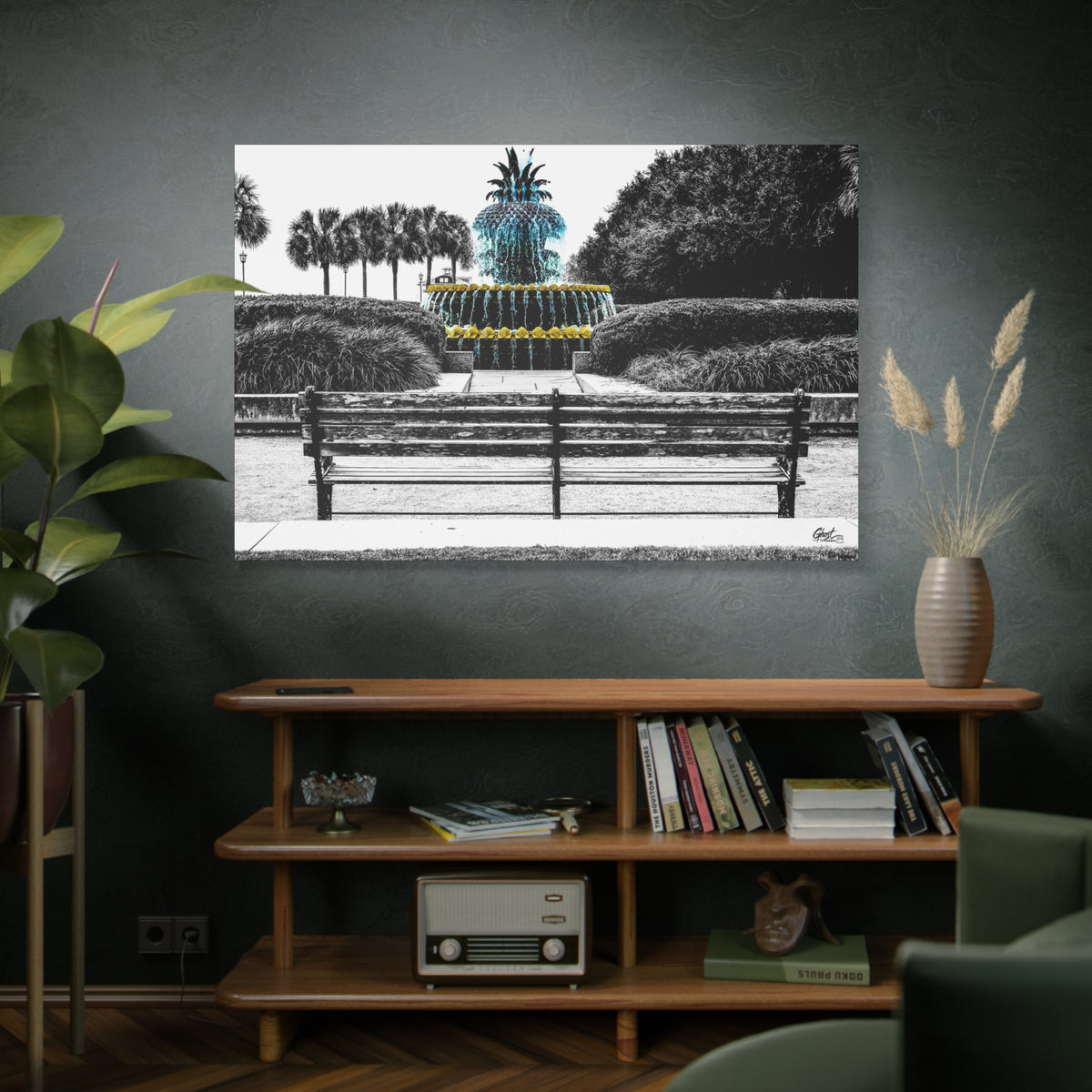 The Pineapple of Peace oversized canvas above a wooden bookshelf, stylized pineapple fountain with palmettos and a park bench