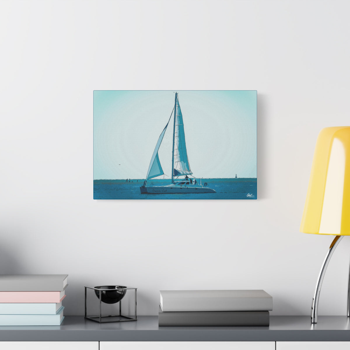 Freedom Sailing large canvas beside a yellow desk lamp, lone sailboat on soft aqua and teal water