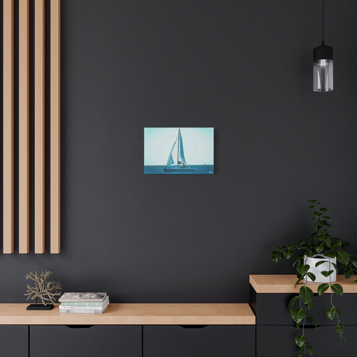 Freedom Sailing small canvas on a charcoal wall over an oak shelf, painterly teal seascape with a single sailboat