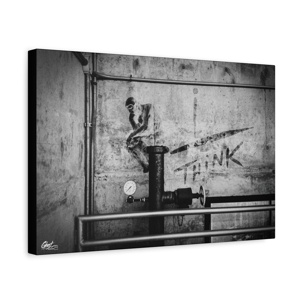 I Overthink canvas, angled side view: stenciled THINK with pipes and gauges on concrete, black and white