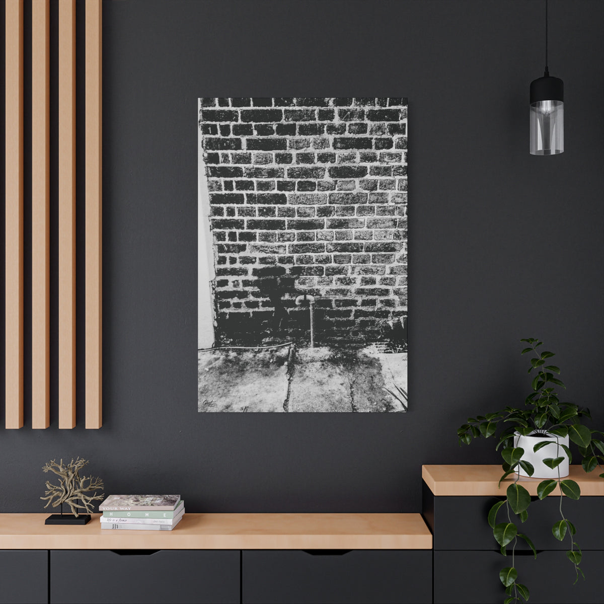 A Little Hiking in Charleston canvas on a charcoal wall by wood slats, high-contrast brick wall with a tiny stencil hiker