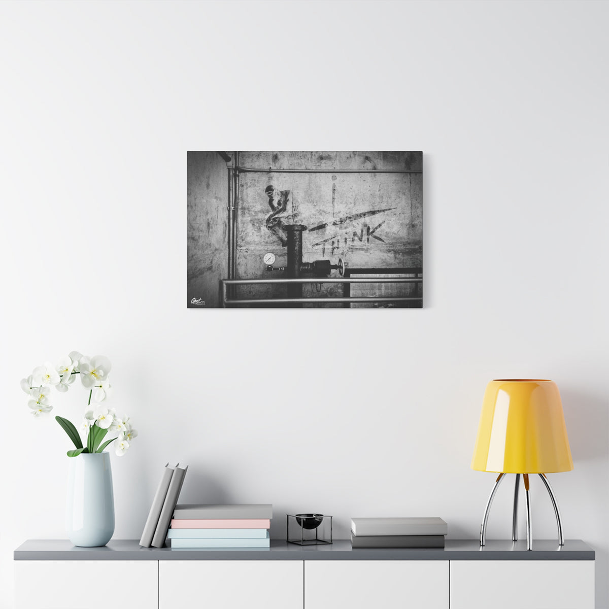 I Overthink oversized canvas on a white wall above a console, gritty parking-garage wall with a stenciled THINK