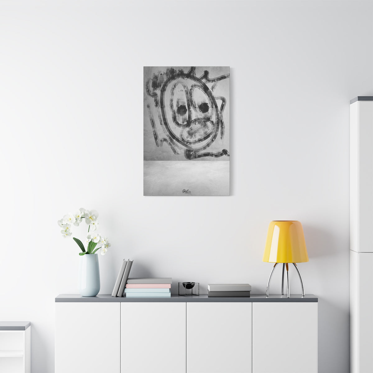 Thinking Out Loud small canvas above a white sideboard and yellow lamp, graffiti-style screaming face in charcoal strokes on concrete