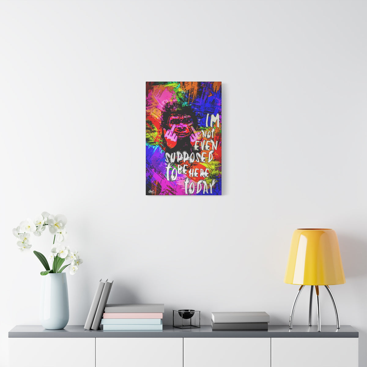 Not Even Supposed to Be Here medium canvas over a console with white flowers, grinning ape in hot pink and neon brushstrokes