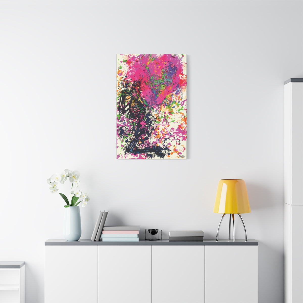 Waiting on My Love canvas above a white sideboard and yellow lamp, kneeling skeletal figure under a fuchsia splatter heart