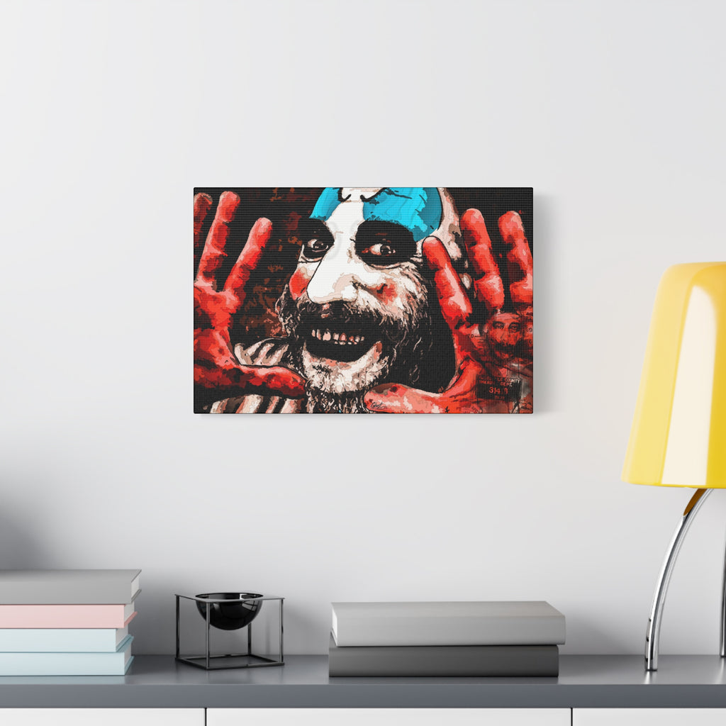 Don't Turn Your Back oversized canvas beside a yellow desk lamp, grinning clown with blue-and-white face paint and red hands