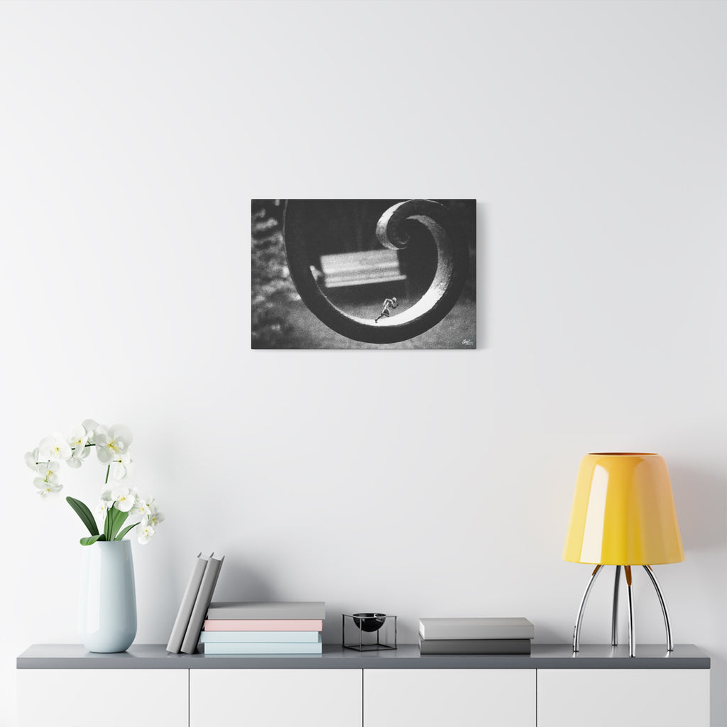 A Man in Charleston small canvas over a console with white flowers, tiny running figure inside a curled wrought-iron scroll in grainy black and white