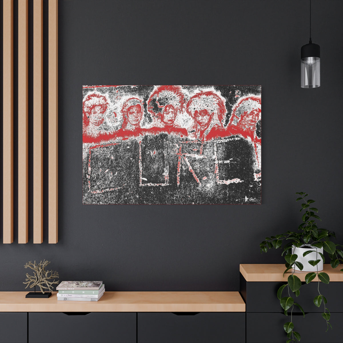 Lowcountry Medicine large canvas on a charcoal wall by wood slats, red-outlined faces over engraved lettering in a grungy sidewalk