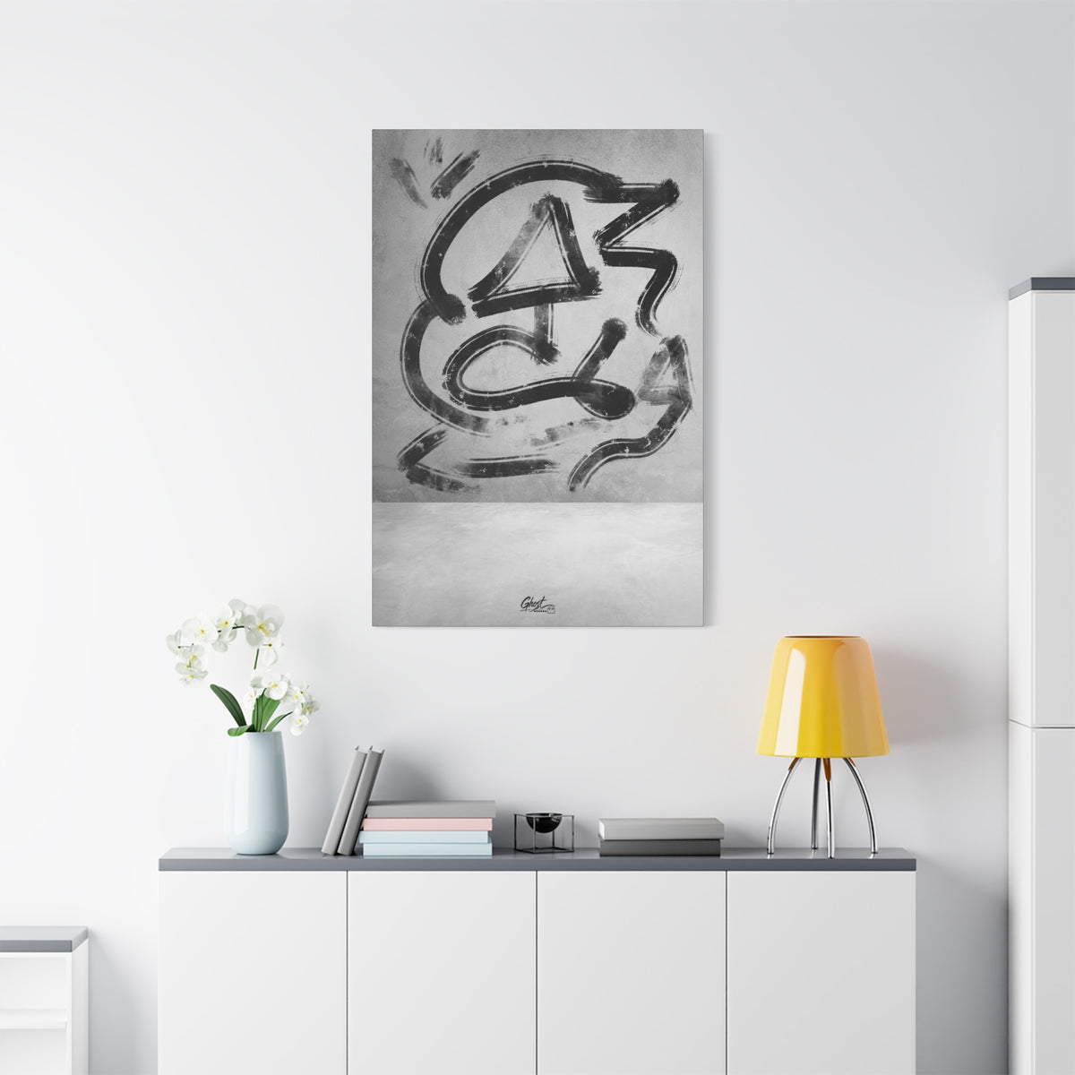 All Nature medium canvas above a white sideboard and yellow lamp, sweeping black gestural brushstrokes on a light ground
