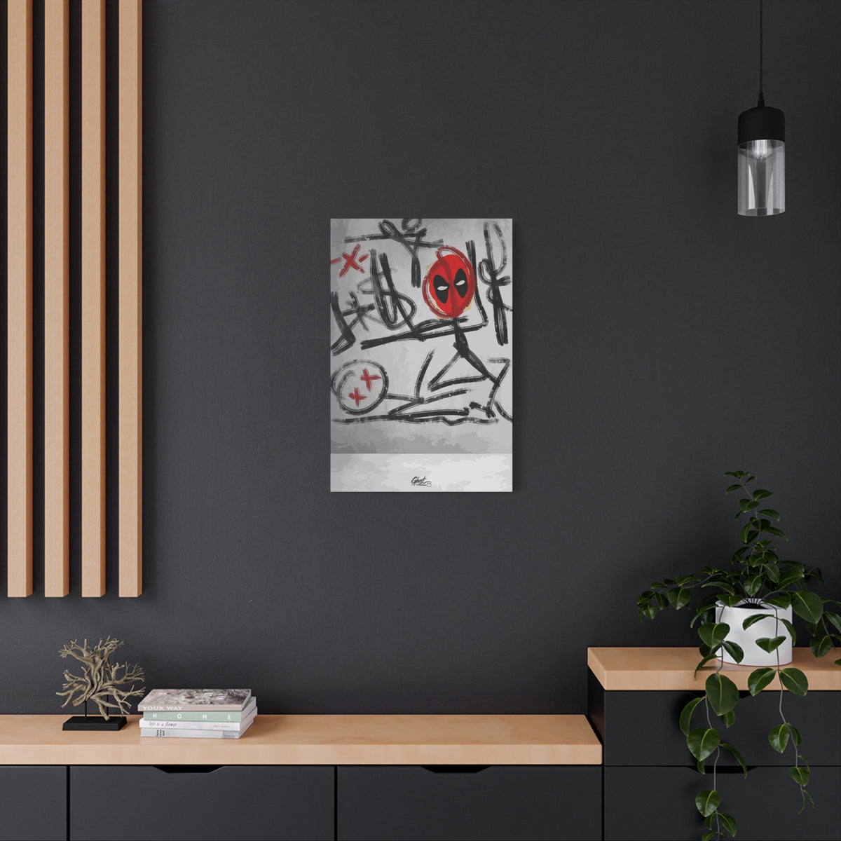 X'd Out medium canvas on a charcoal wall over an oak shelf, black brushstroke doodles with a red mask emblem