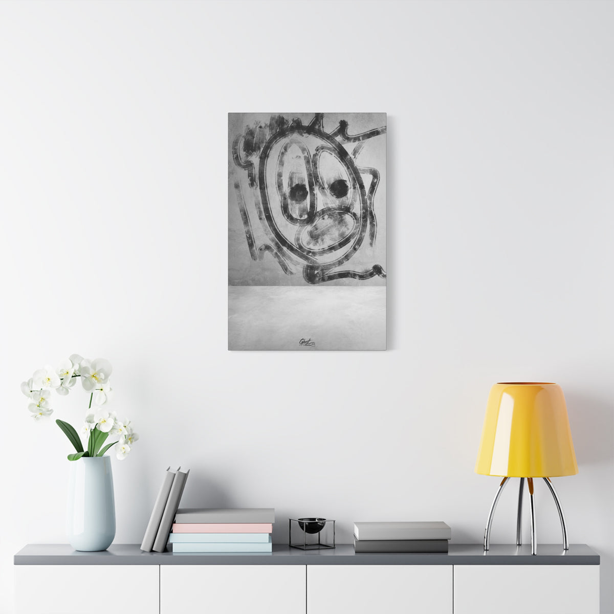 Thinking Out Loud large canvas on a white wall above a console, black-and-white abstract face with blurred edges